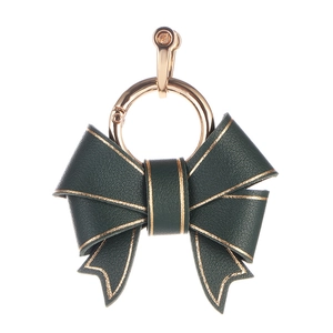 Luxurious dark green leather bow keychain with elegant gold trim and metal hardware
