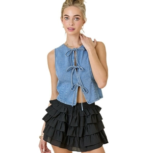 Lace-up blue denim vest paired with black ruffled tiered skirt for women's chic casual style