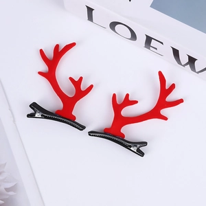 Detail of red Christmas reindeer antler hair clips with textured flocking and metal duckbill clips