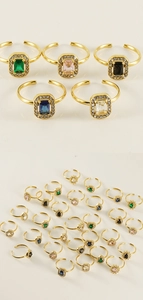 Detail of adjustable 18K gold rings with colorful zirconia stones in various shapes