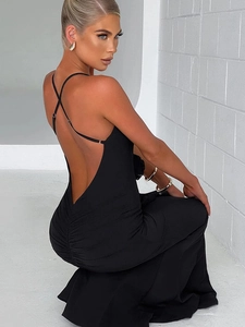 Detail of a slim-fit black backless dress with elegant ruffles and side ruching details