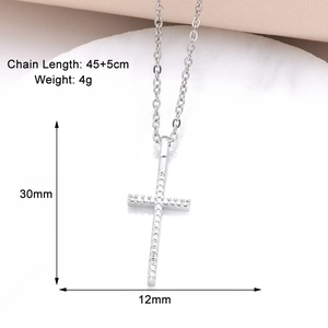 Macro shot of silver cross pendant with crystals showing 30mm x 12mm dimensions and 4g weight