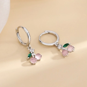 Close-up of S925 silver cherry earrings with pink cat eye stones and green leaves