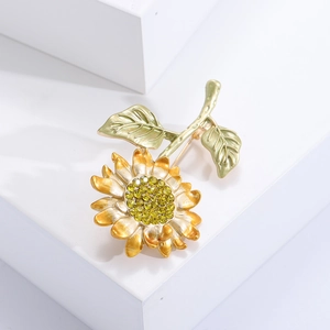 Detail of yellow sunflower brooch with enamel petals and sparkling rhinestone center