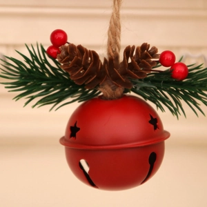 Macro view of a red Christmas bell with pine cones, berries, and rustic twine cord