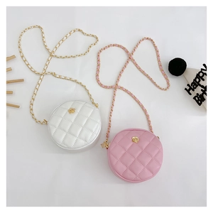 Detail of round mini crossbody bags featuring quilted faux leather and gold flower charms