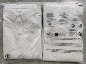 Detailed view of white jacquard knit polo shirt with wave texture and material tag