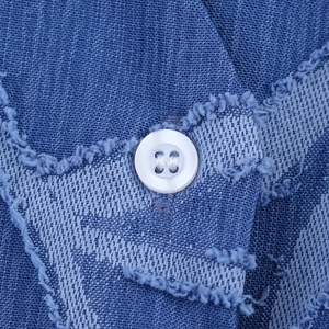 Women's blue denim jacquard set featuring textured vest with white buttons and fringe details