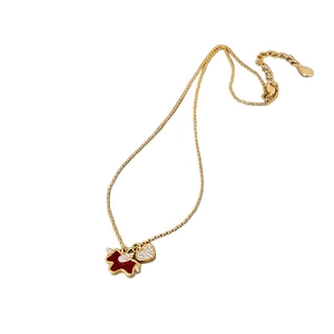 Gold plated necklace with red enamel puppy and zircon heart pendant on white backdrop