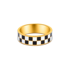 Close-up of golden stainless steel ring featuring a black and white checkerboard pattern