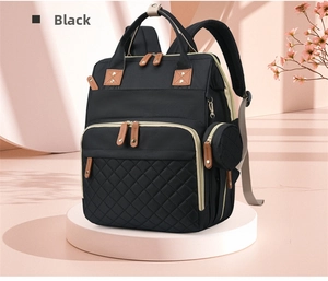 Detail of black diaper backpack with diamond quilting and detachable coin purse