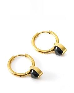Close-up of gold hoop earrings featuring a faceted black teardrop zircon pendant