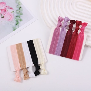 Close-up of assorted colorful elastic knotted headbands on white display cards for women