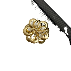 Elegant gold vintage metal camellia brooch with matte finish and spiral center detail