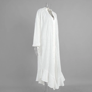 Detailed close-up of intricate white Broderie Anglaise embroidery on a summer maxi dress