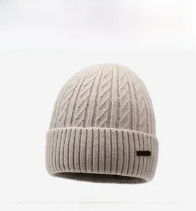 Close-up of cable-knit texture and ribbed cuff on a warm winter beanie hat