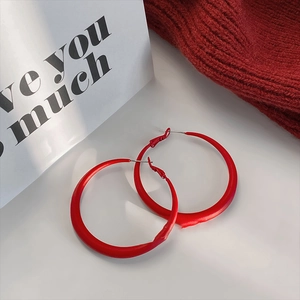 Minimalist red hoop earrings for women with matte finish on clean aesthetic background
