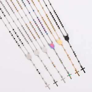 Religious rosary necklaces in gold, silver and black with cross and medal on white background