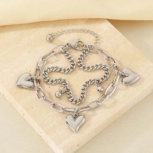 Detail view of double-layer silver steel heart bracelet with polished charms and chain links
