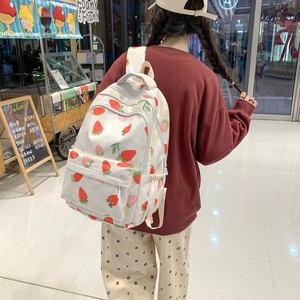 Detail view of strawberry print backpack showing its large capacity and canvas texture