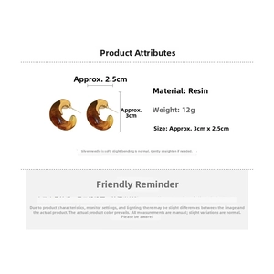 Detail view of amber resin C-shape earrings with size dimensions and 12g weight specification