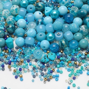 Macro view of assorted blue glass seed beads and tubes for DIY jewelry making