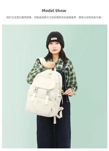 Detail of cream backpack with cartoon bear prints and cute black doll keychain