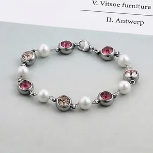 Elegant crystal bracelet with white pearls and champagne stones on a soft background