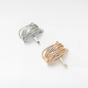 Detail of U-shaped metal hair hooks in silver and rose gold finishes for ponytails