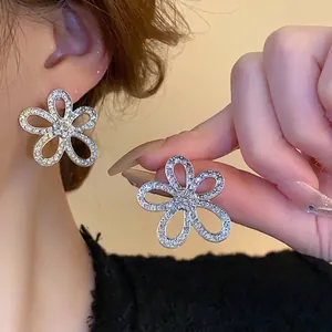 Elegant hollow flower stud earrings in silver finish with micro-set sparkling crystals