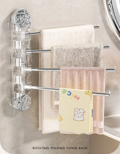 Close-up of four-bar rotating folding towel rack with acrylic base on marble wall