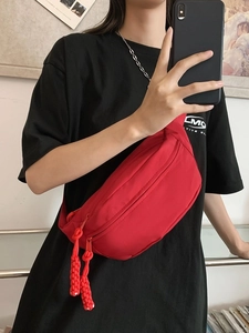 Bright red nylon crossbody sling bag with dual zippers and adjustable black strap for women