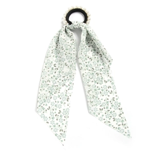 Detailed shot of light green floral silk ribbon hair tie with white pearl embellishments