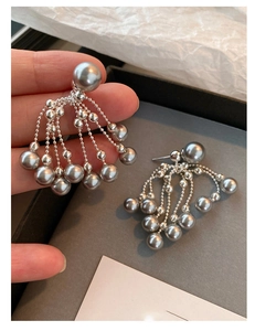 Detailed view of grey pearl tassel earrings featuring elegant silver metal fringe