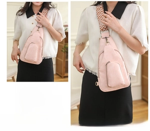 Pink PVC crossbody bag with ethnic geometric wide strap shown on model in cozy interior