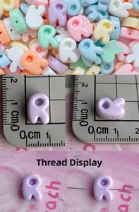 Macro detail of colorful macaron resin letter R beads with side holes for DIY jewelry