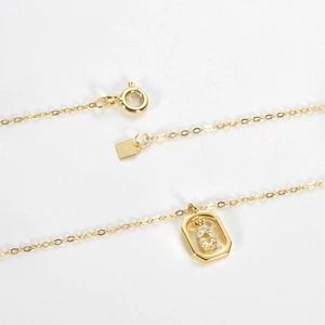 Close-up of S925 silver necklace with hexagonal letter D pendant and crystal detail