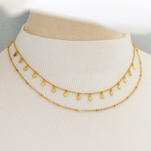 Double-layer 18K gold plated necklace with spotted geometric discs on white sweater