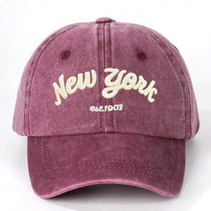 Macro detail of New York embroidery on washed cotton burgundy baseball cap