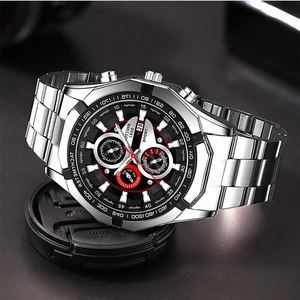 Macro shot of silver stainless steel watch with black chronograph dial and date display