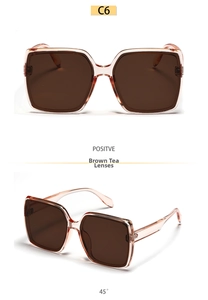 Detailed view of oversized amber square sunglasses with dark brown lenses at 45-degree angle