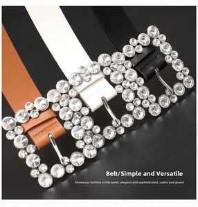 Close-up of three women's belts with sparkling diamond-encrusted rectangular alloy buckles
