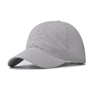 Close-up of laser-cut perforated breathable mesh fabric on dark grey sports cap