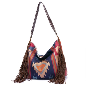 Detail of bohemian tote bag featuring colorful geometric patterns and long navy fringes