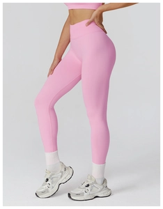 Detail view of pink high-waist seamless yoga pants showing elastic knit fabric and shaping fit