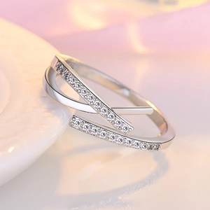 Macro detail of silver double-layered crisscross ring with micro-pave white zircons