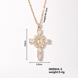 Detail shot of gold cross necklace with virgin mary icon and clear cubic zirconia