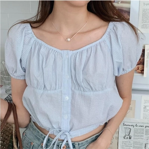 Detail of light blue striped puff sleeve top with square neck and button front design