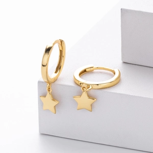 Minimalist S925 sterling silver hoop earrings with hanging gold star charms on white block