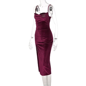 Detailed macro shot of the side slit and gathered velvet texture on the burgundy dress